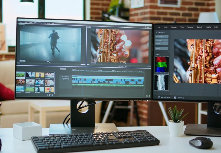 Empty office desk with a video editing software running on computer, video production and mixing to edit footage. Professional program for filmmaking media, creative studio.