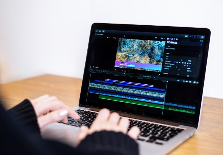 Young content creator girl editing video on her laptop. Working from home